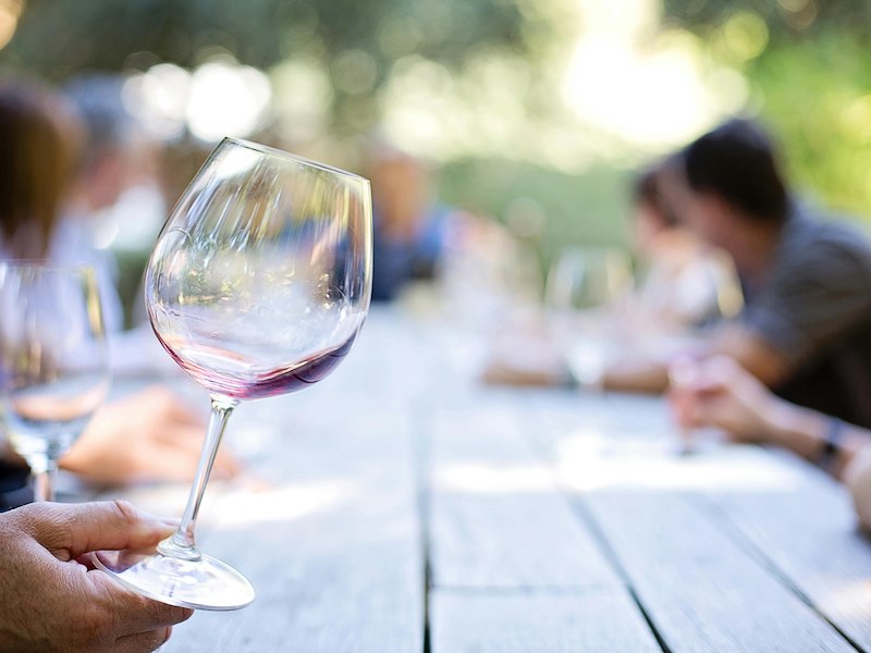 A person holding a wine glass