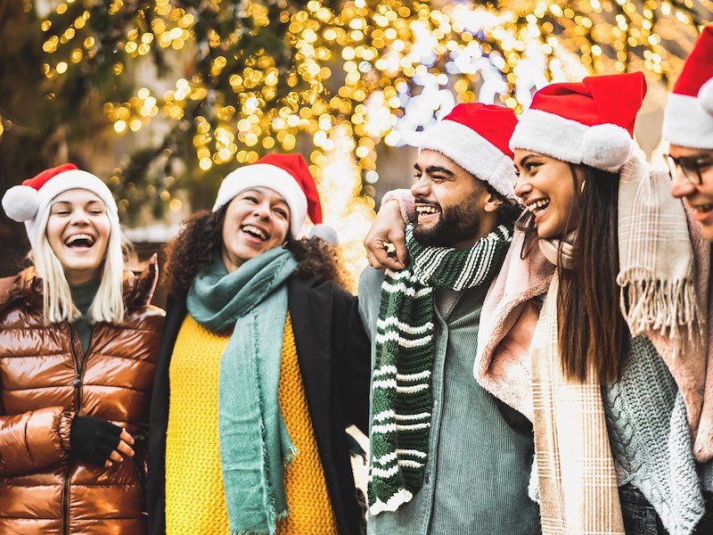 A group of people wearing santa hats and scarves