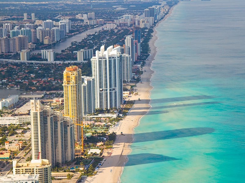 Aerial view of miami beach high-rises along the coastline 