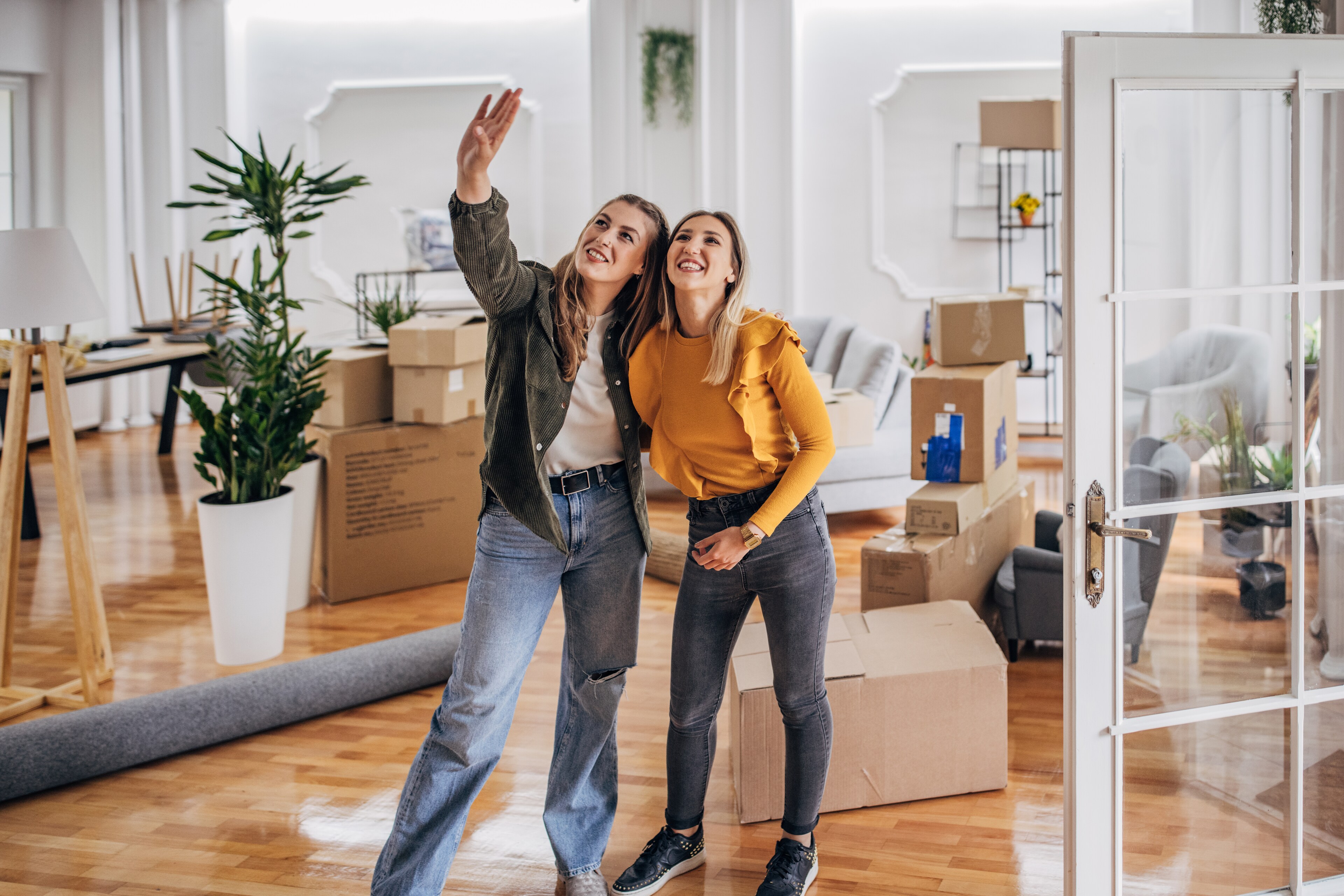 Two young women inside a new home