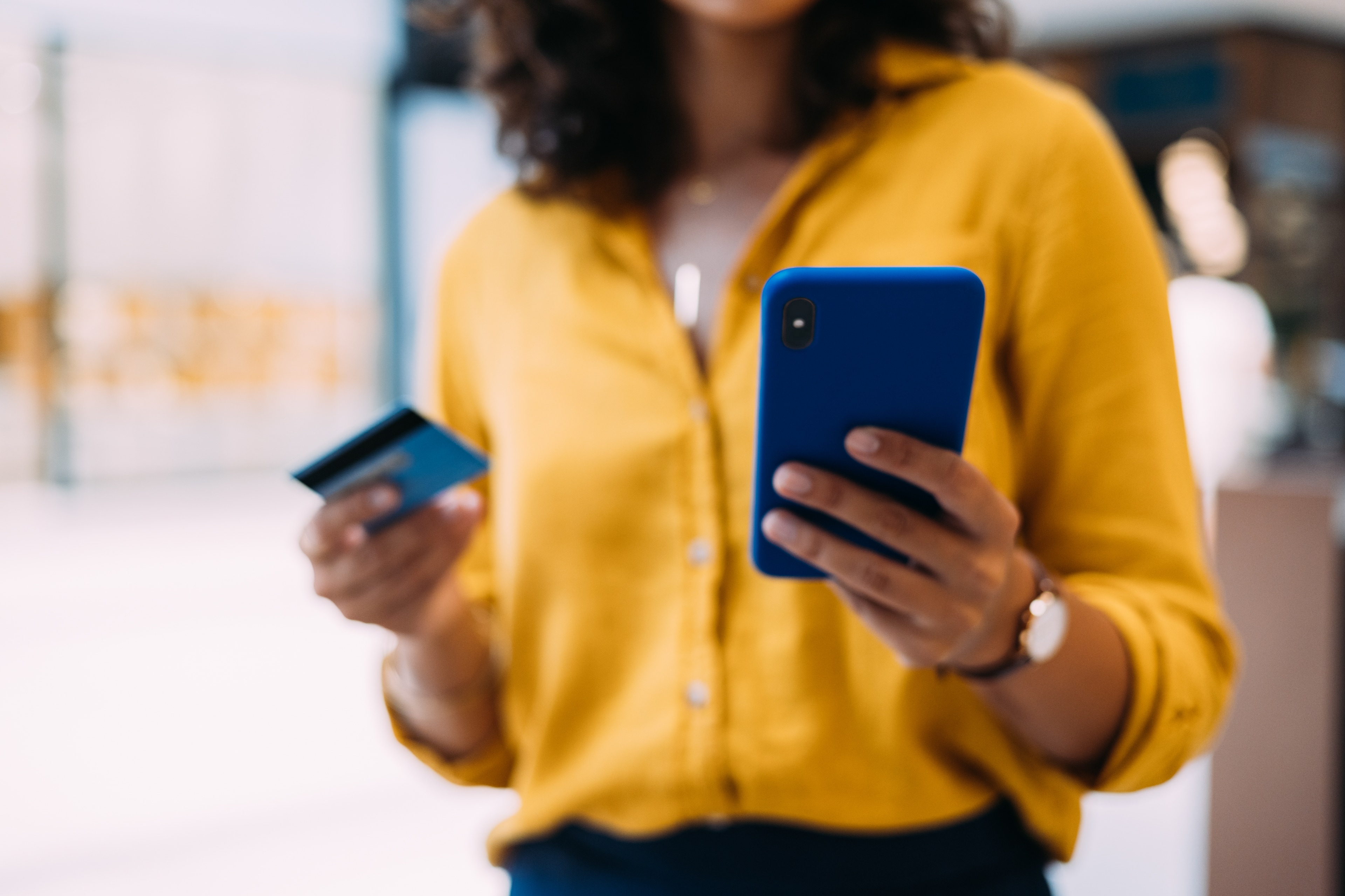 Close Up Of Person Holding Credit Card And Mobile Phone For Payment
