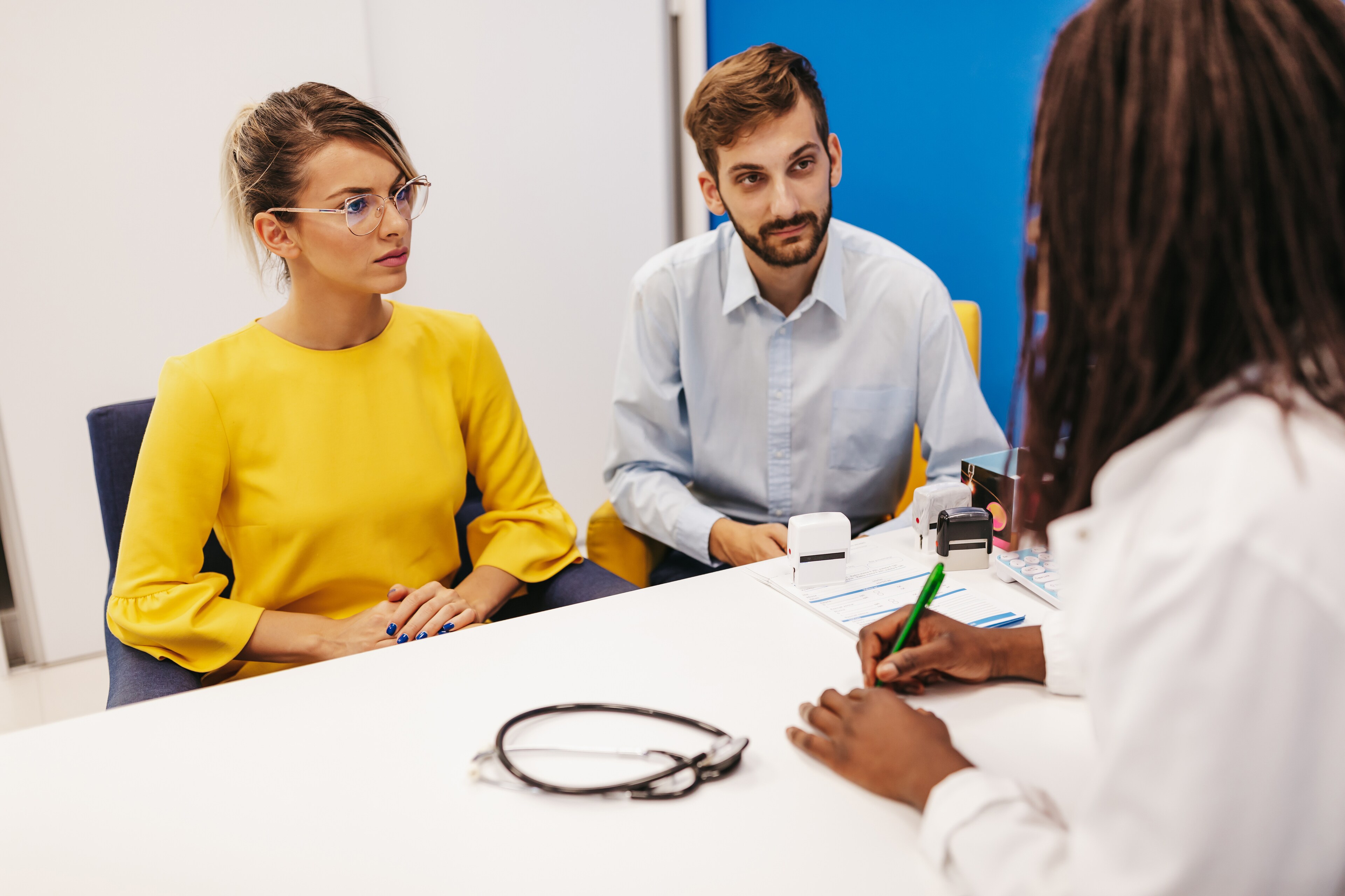 Couple meeting with a healthcare professional at an office desk