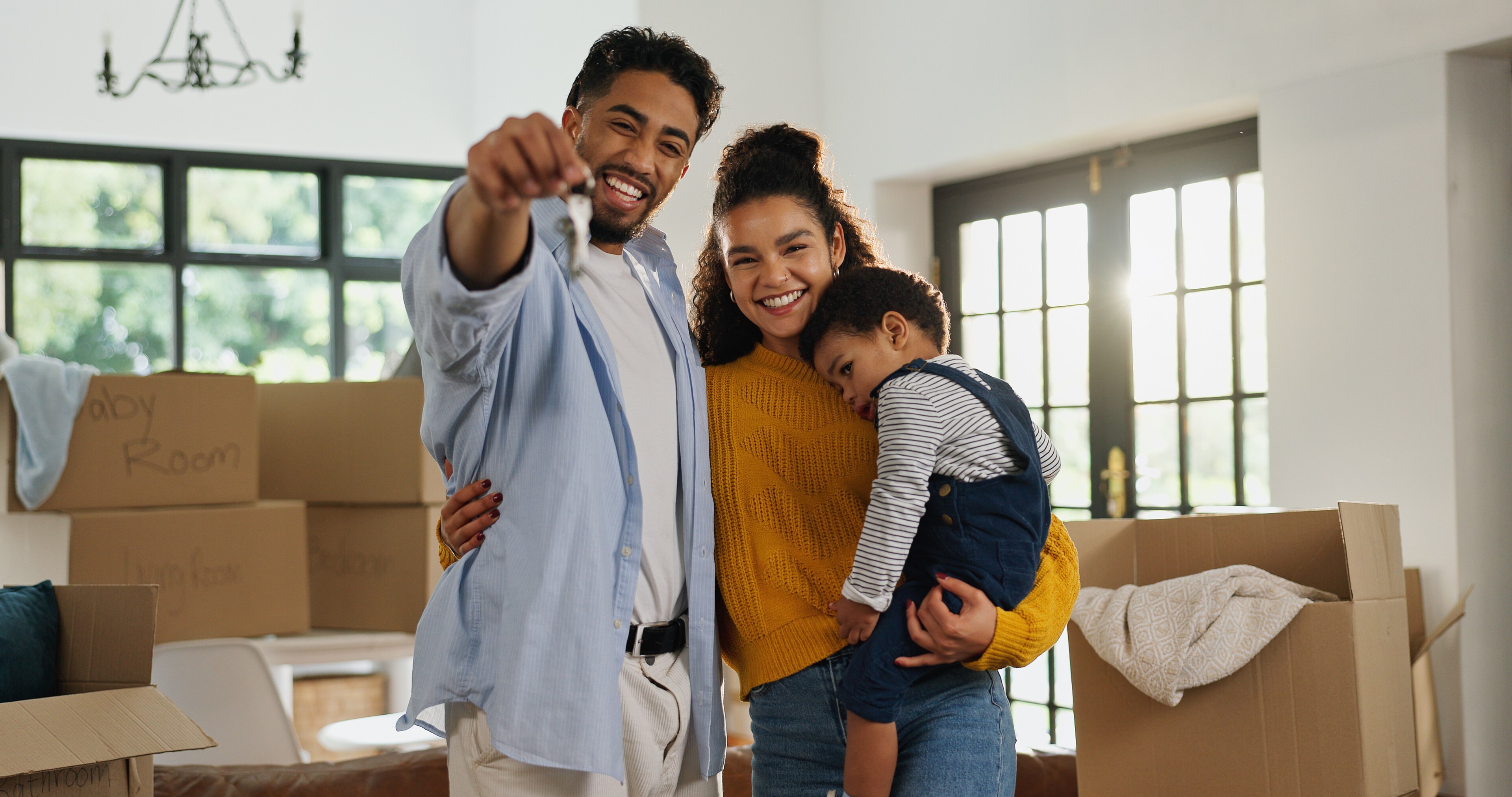 Happy Family With Toddler Holding Up New House Keys