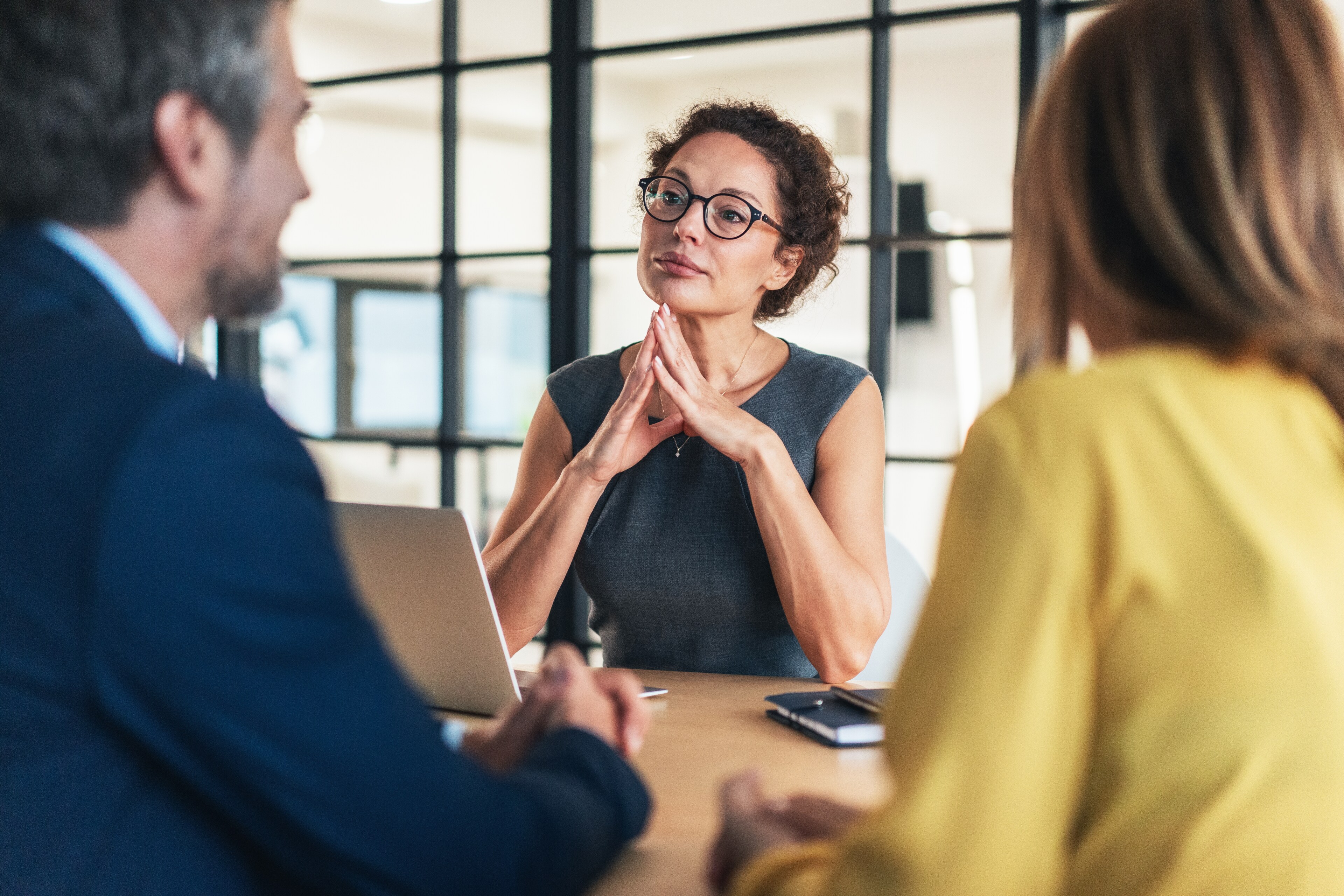 Professional Financial Advisor In Glasses Listening In Meeting