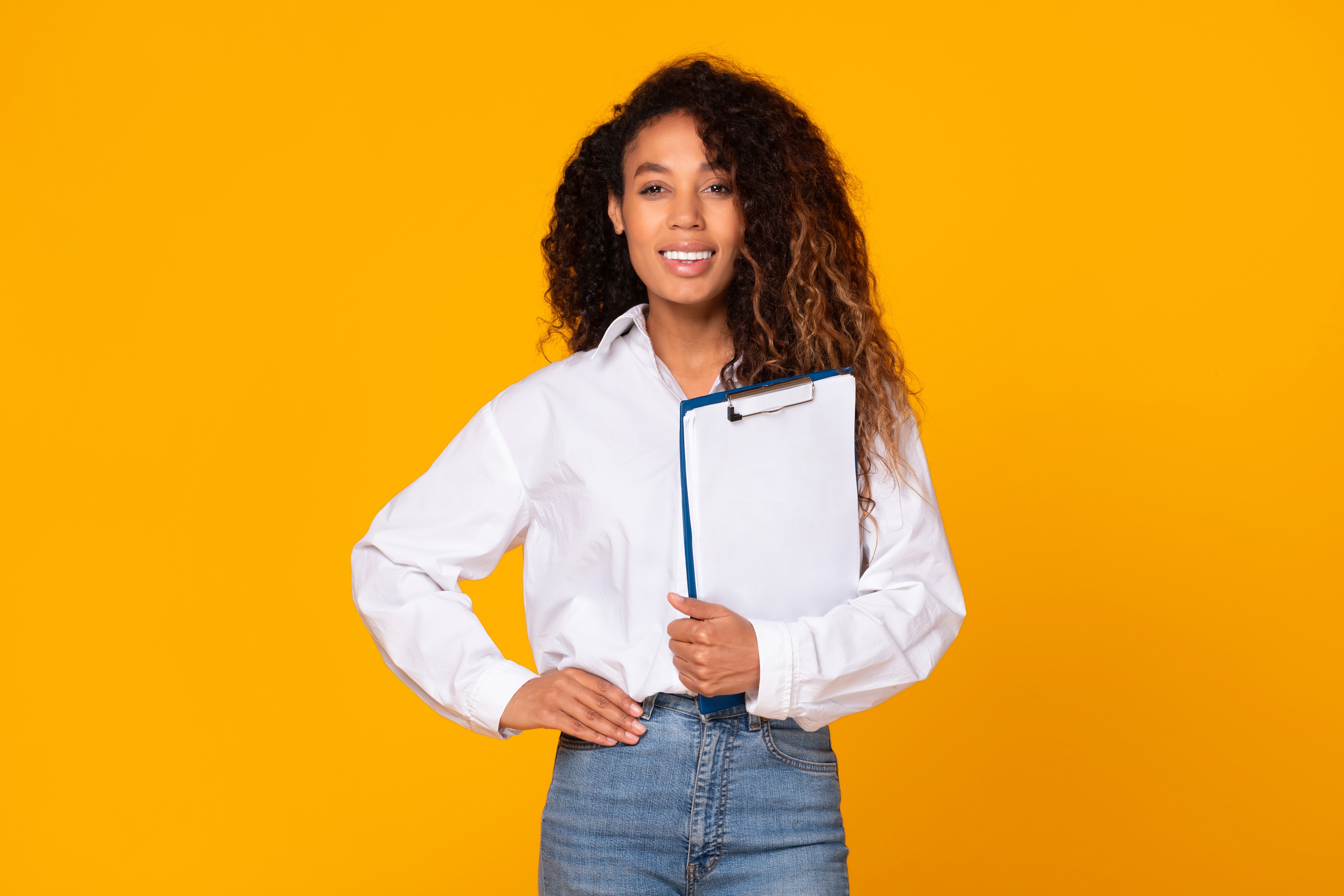 Smiling woman holding a clipboard