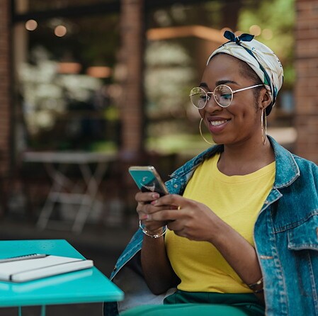 Smiling woman texting on smartphone at Colorado