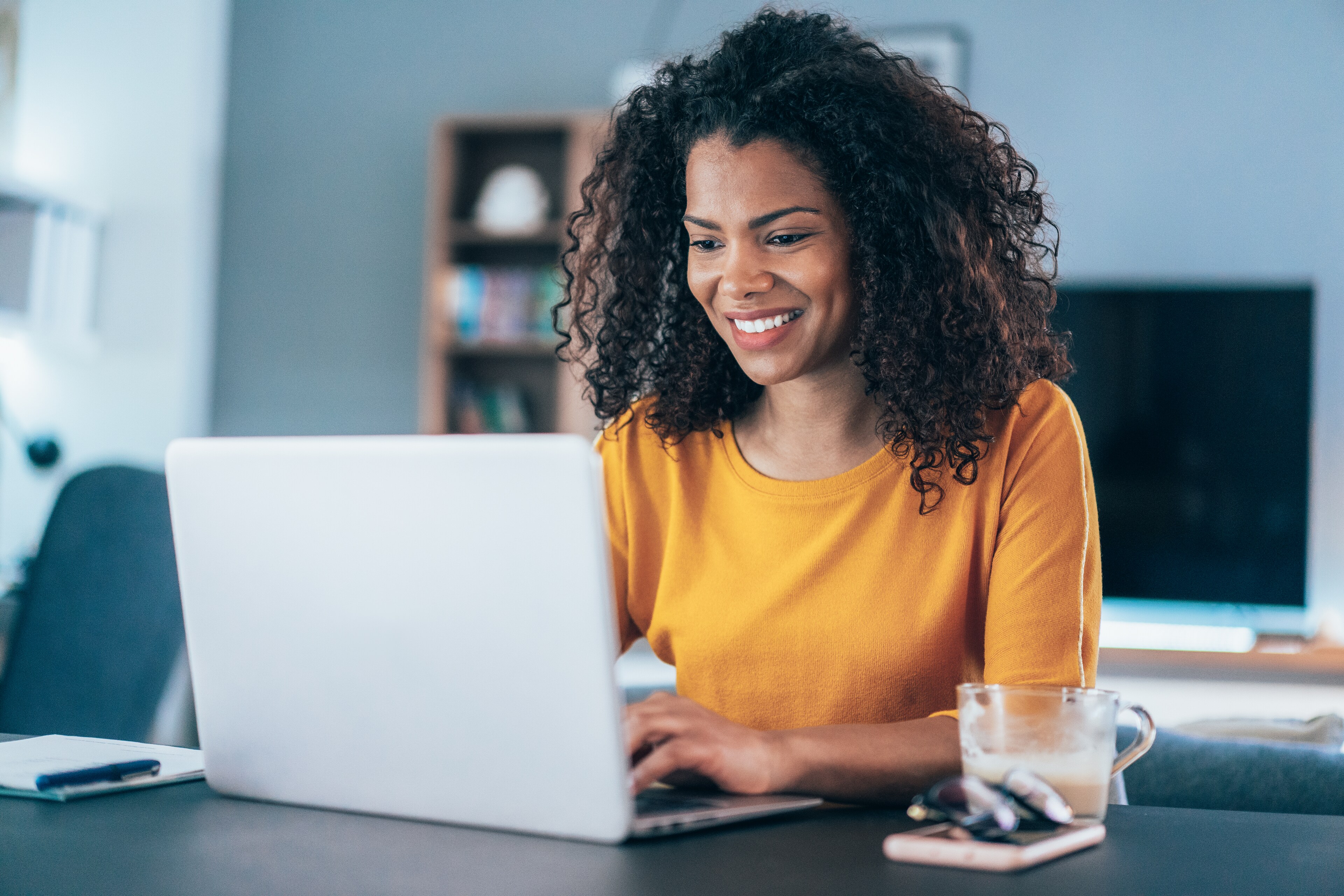 Smiling woman working on her laptop at Colorado