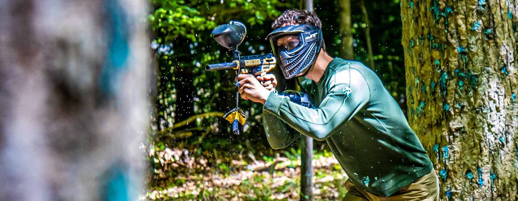 A person in protective gear aims a paintball gun Adventures on the Gorge - Lansing West Virginia USA