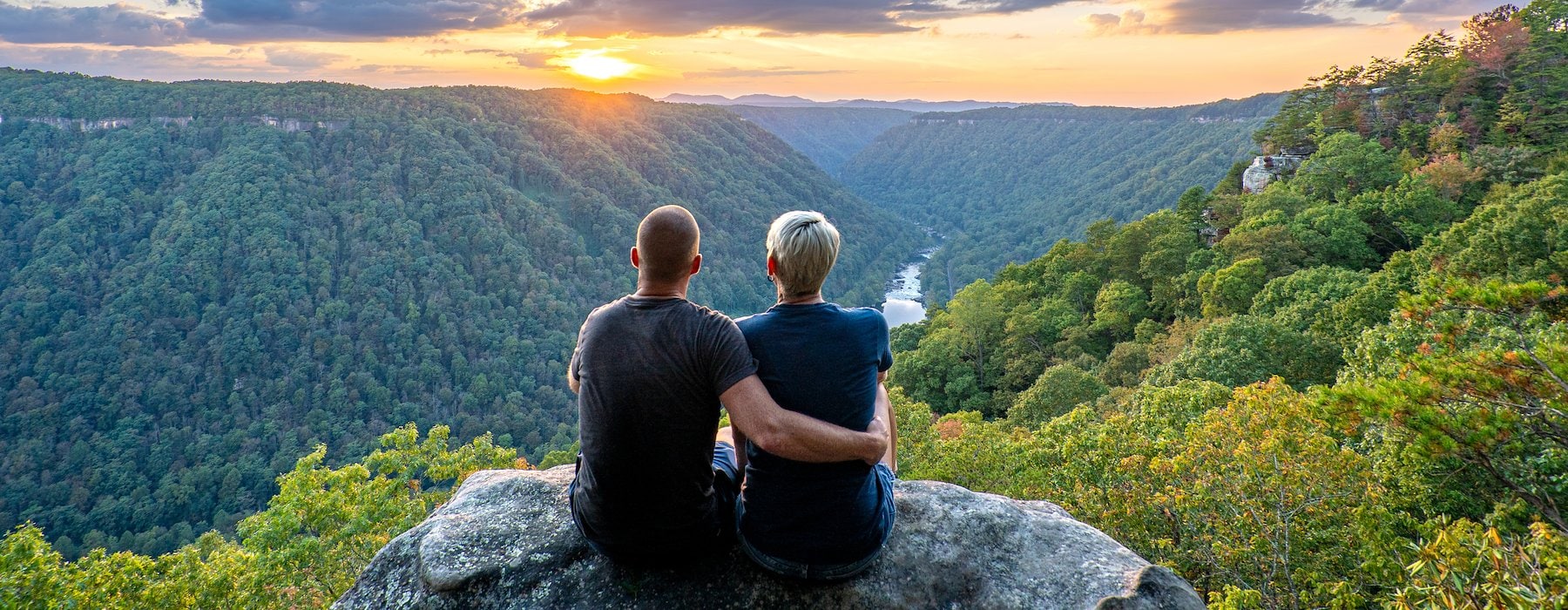 Adventures on the Gorge Lansing West Virginia USA - Couple sitting on a cliff rock Embracing