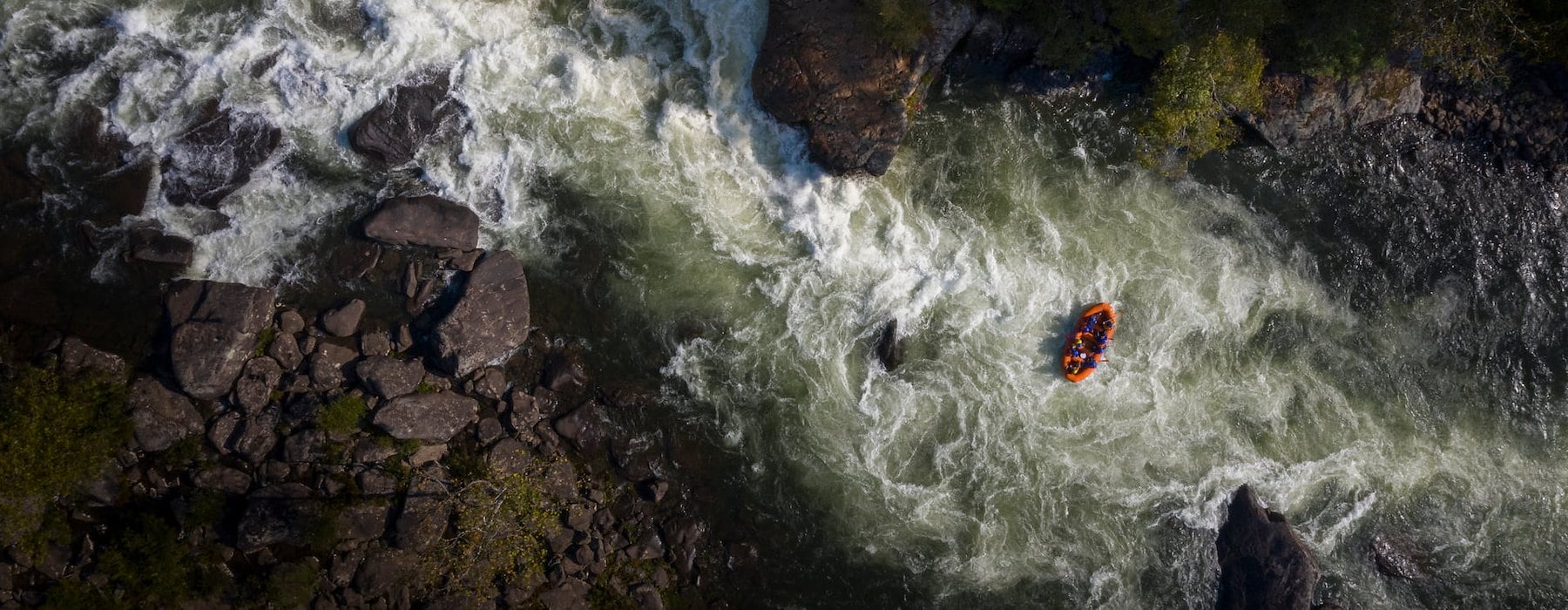 Aerial view of a raft navigating through white-water rapids Adventures on the Gorge - Lansing West Virginia USA