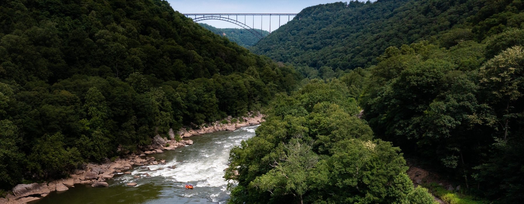 Aerial view of orange rafts navigating a river surrounded Adventures on the Gorge - Lansing West Virginia USA