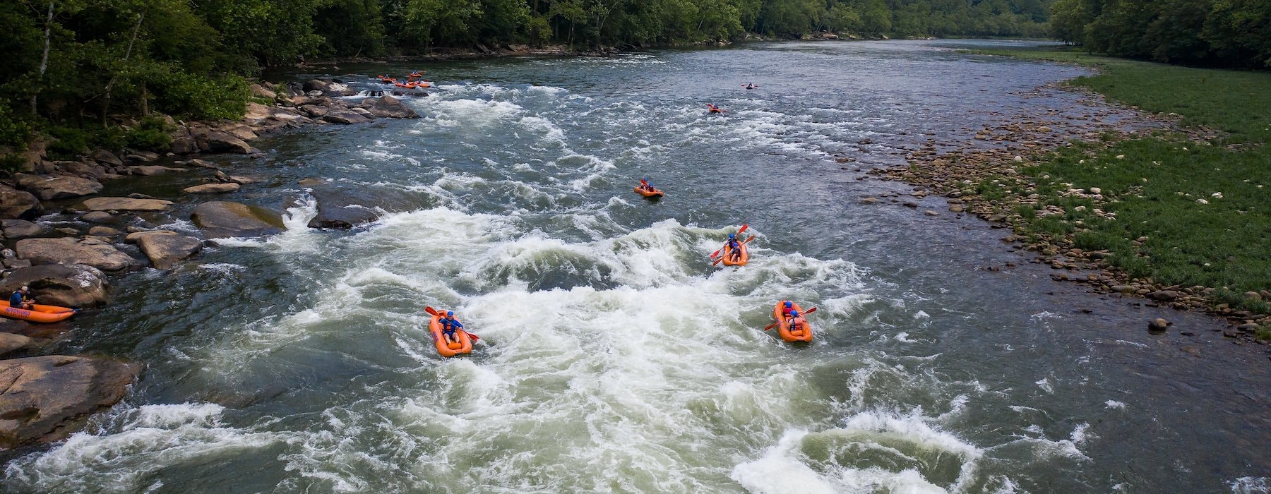 Group of kayakers navigates a fast-flowing river surrounded Adventures on the Gorge - Lansing West Virginia USA