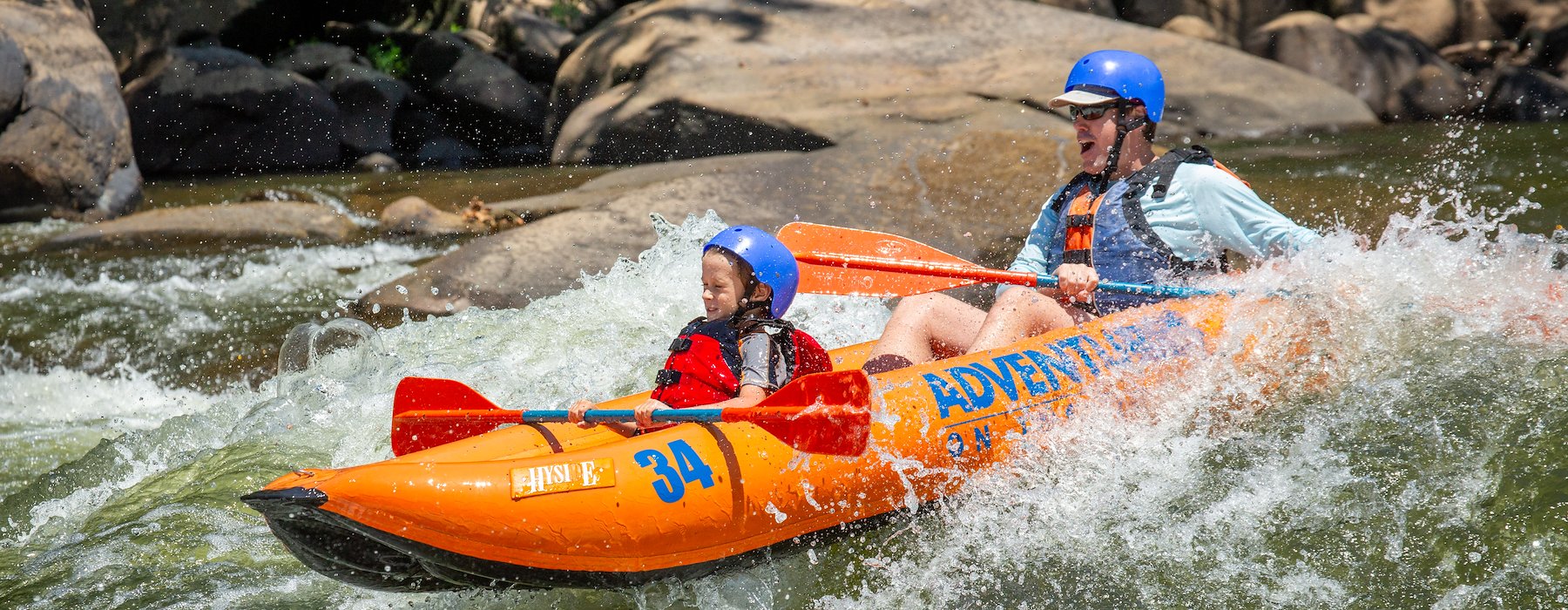 life vests navigate kayak through white-water rapids Adventures on the Gorge - Lansing West Virginia USA