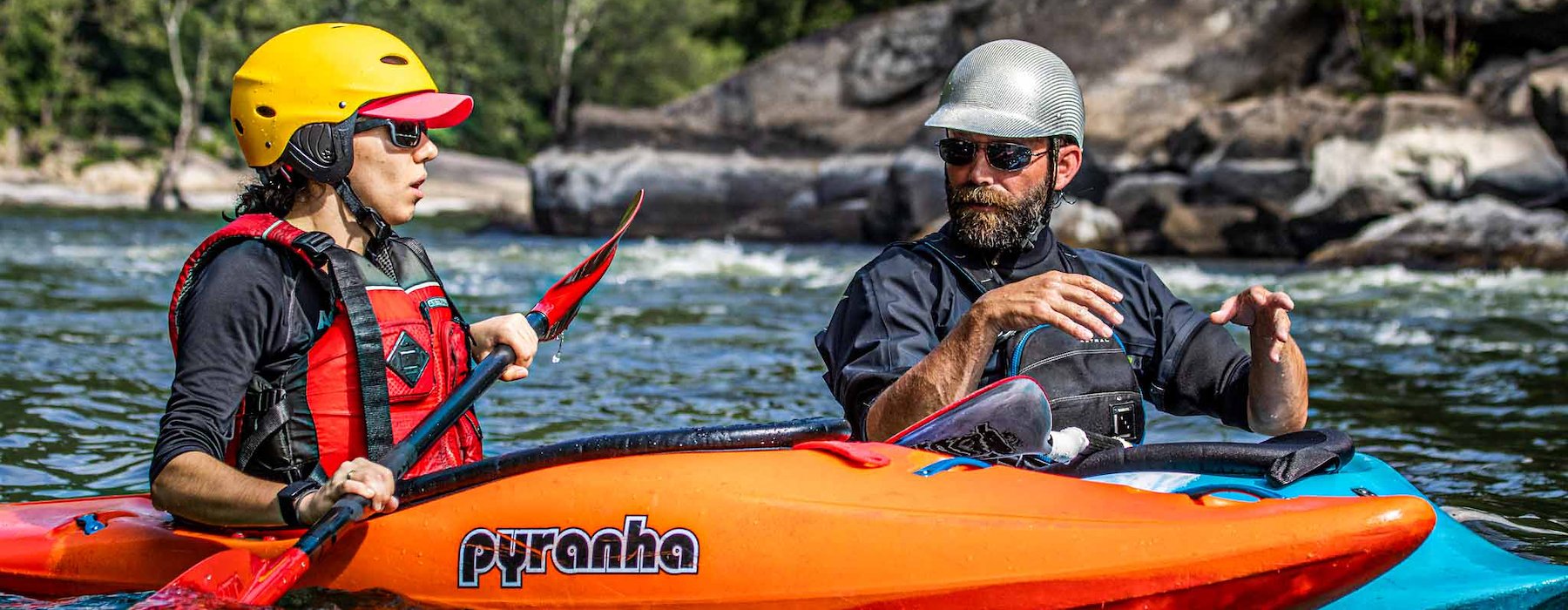 Two kayakers in vibrant gear converse on a river Adventures on the Gorge - Lansing West Virginia USA