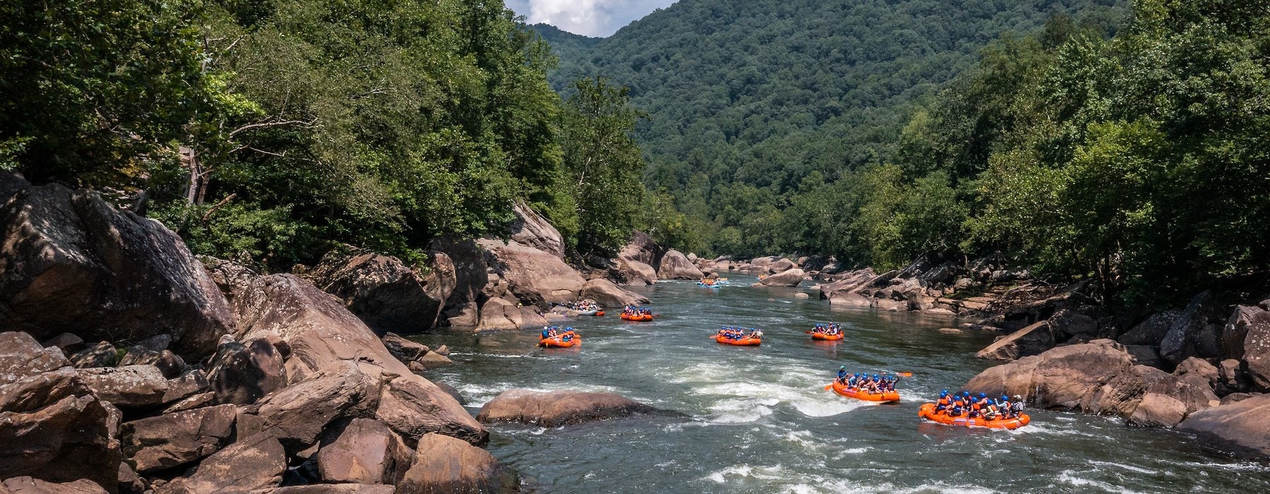 White water rafters navigate a flowing river Adventures on the Gorge - Lansing West Virginia USA