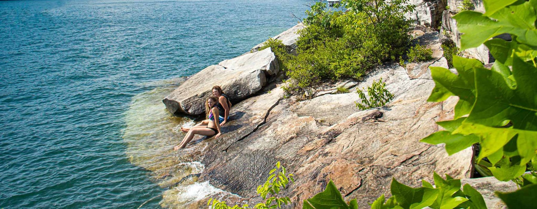 Women relaxes on a rock in the water Adventures on the Gorge - Lansing West Virginia USA