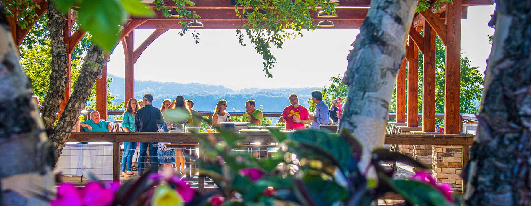 Outdoor gathering under wooden pavilion framed by trees and vibrant Adventures on the Gorge - Lansing West Virginia USA