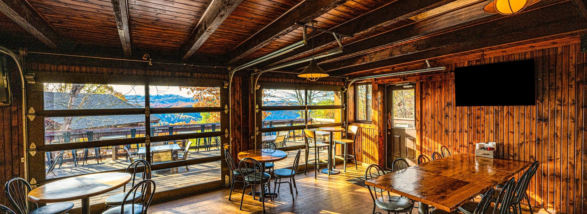 Exterior with two green doors and warm lighting Chetty's Pub Adventures on the Gorge - Lansing West Virginia USA