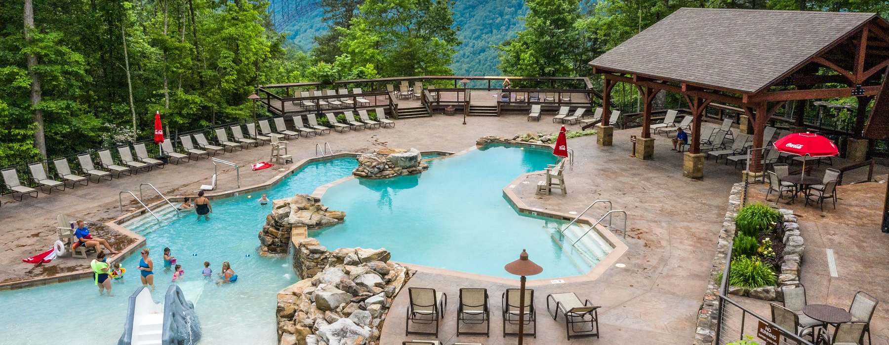 Scenic mountain pool with loungers and umbrellas surrounded Adventures on the Gorge - Lansing West Virginia USA