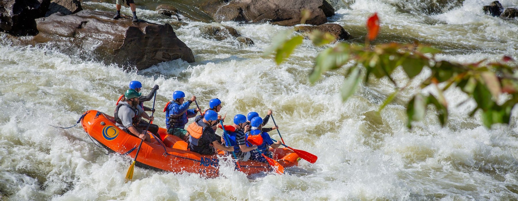 A team of individuals navigating a river in a raft Adventures on the Gorge - Lansing West Virginia USA
