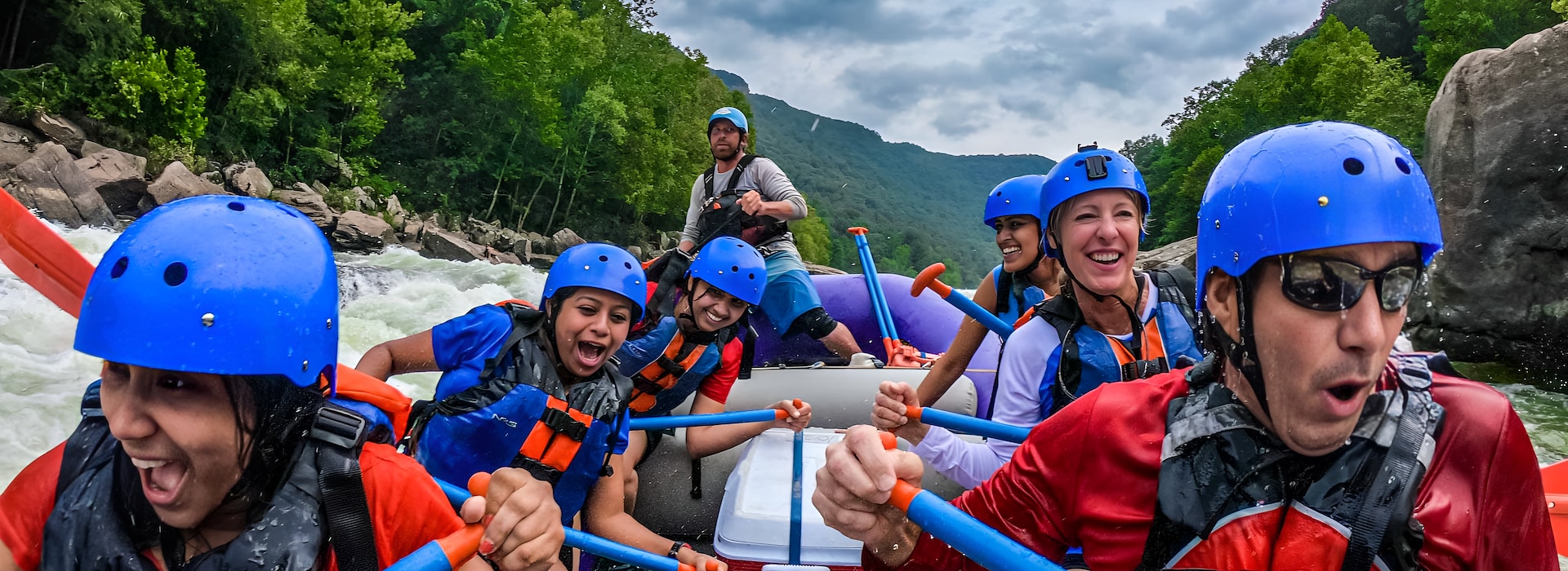 Adventures on the Gorge Lansing West Virginia USA - Group of peoples are navigating a blue raft through turbulent