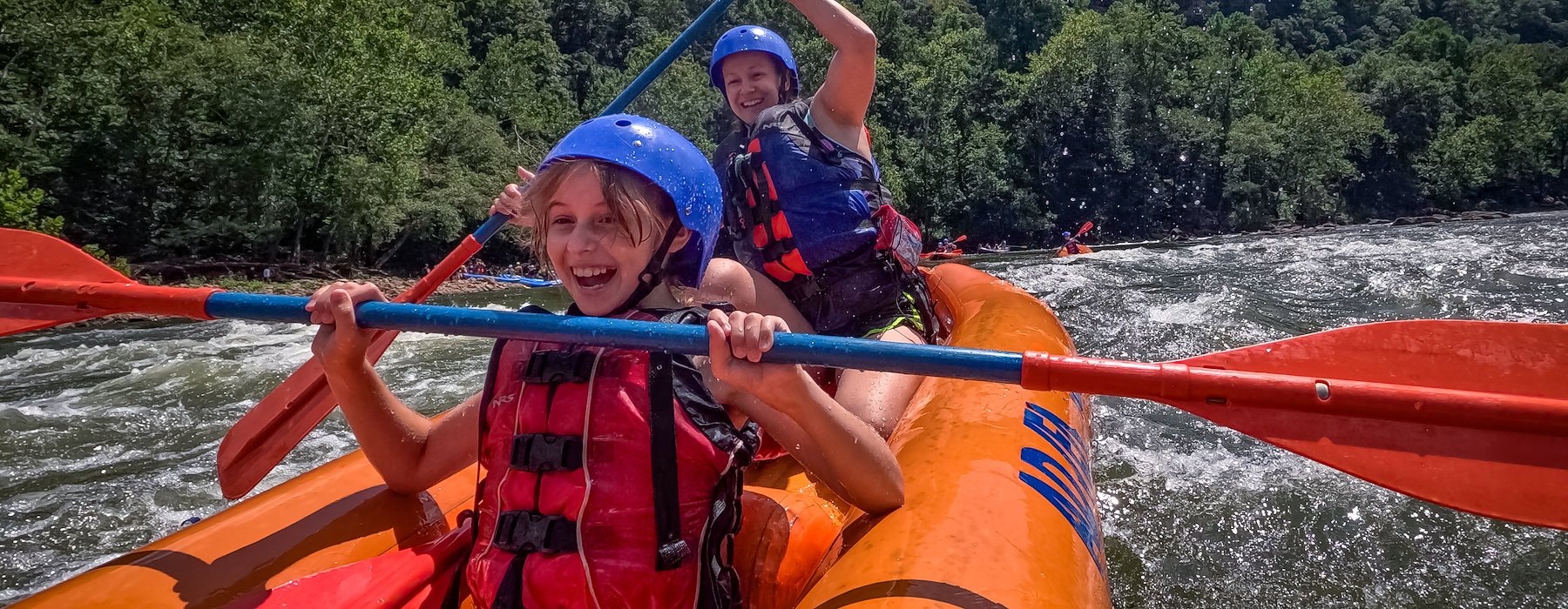 Raft carrying two people glides down a river Adventures on the Gorge - Lansing West Virginia USA