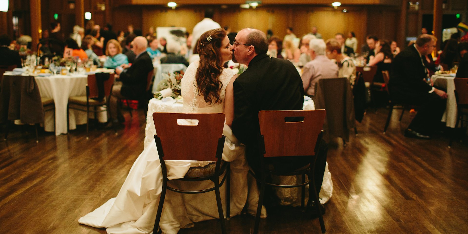A bride and groom share a romantic kiss in a spacious Asilomar Hotel and Conference Grounds - Pacific Grove California