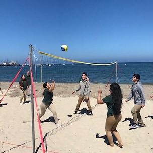 A group of people enjoy a beach volleyball game on a sunny day Asilomar Hotel and Conference Grounds - Pacific Grove California