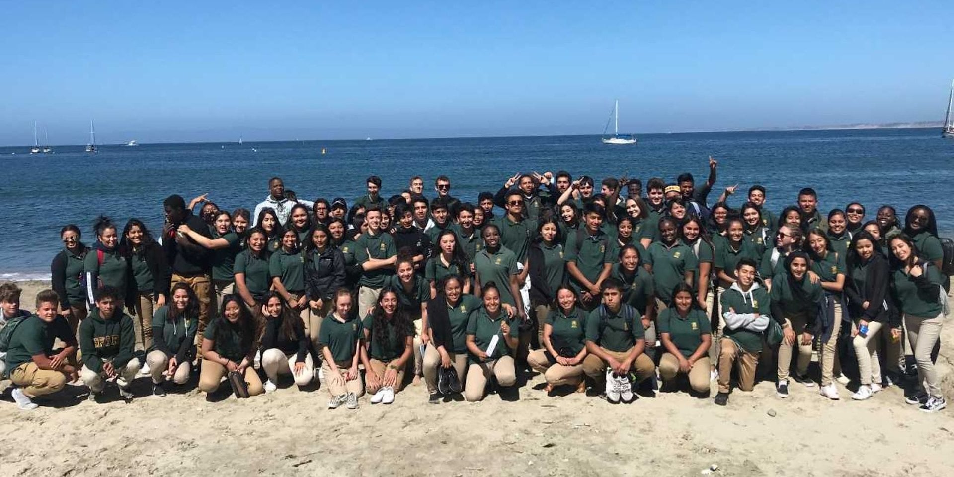 A Team Building pose on a sandy beach with a clear blue sky Asilomar Hotel and Conference Grounds - Pacific Grove California