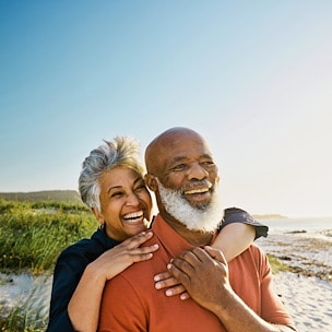 Asilomar Hotel and Conference Grounds Pacific Grove California - A joyful elderly couple embraces on a sunny beach
