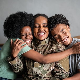 Asilomar Hotel and Conference Grounds Pacific Grove California - A joyful family embrace with a soldier in uniform sitting