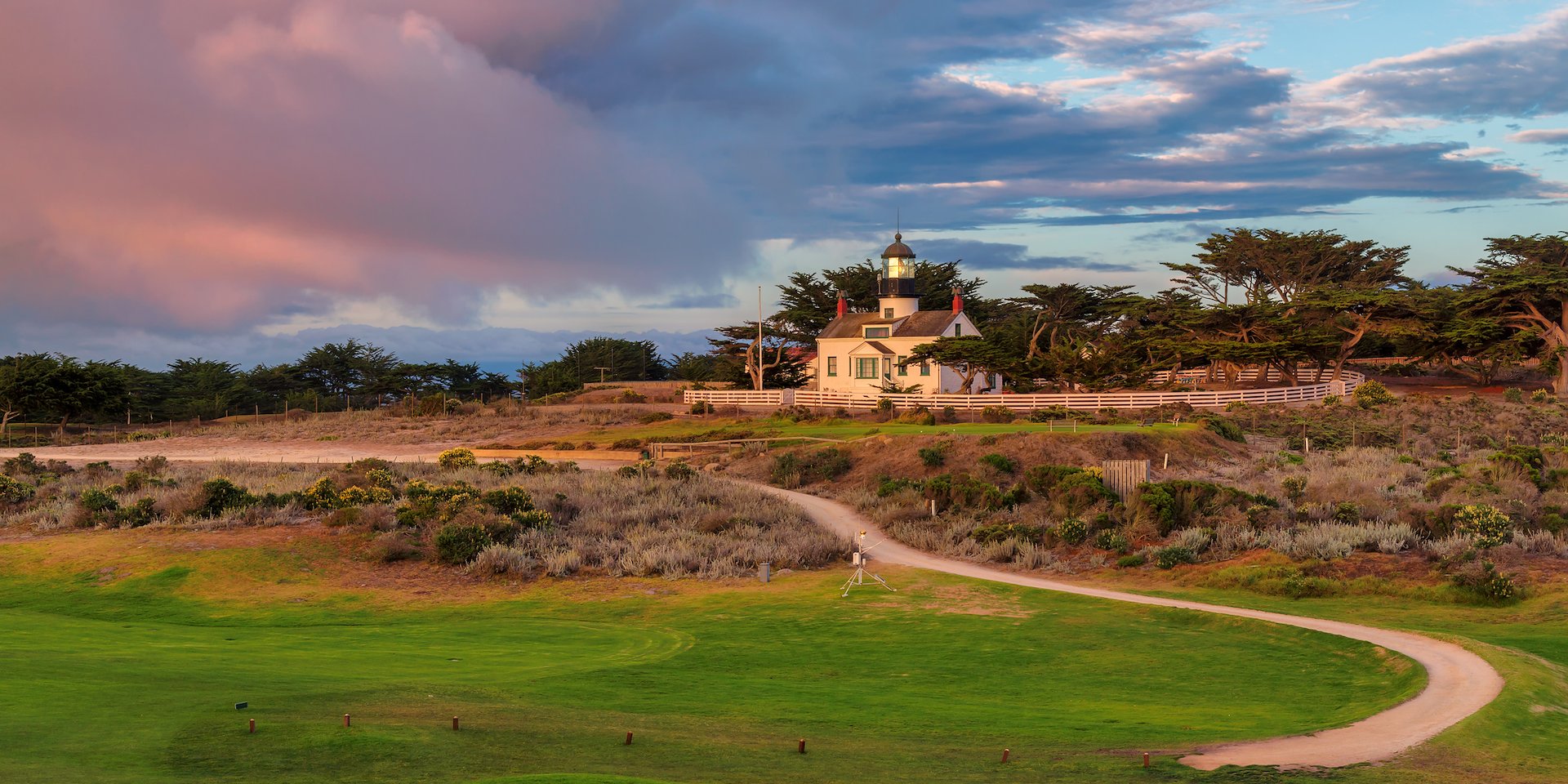 Asilomar Hotel and Conference Grounds Pacific Grove California - A scenic view of a lighthouse on a grassy hill during sunset