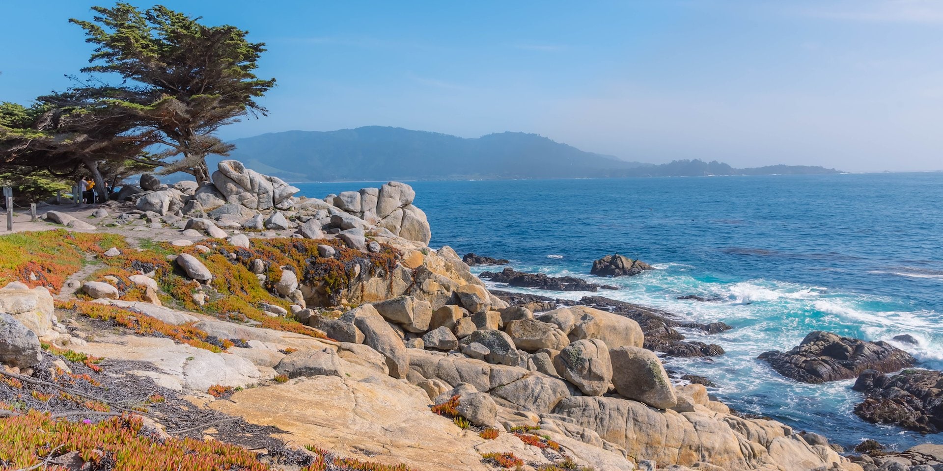 Asilomar Hotel and Conference Grounds Pacific Grove California - Coastal scene with lush greenery and rocky outcrops leading to a calm