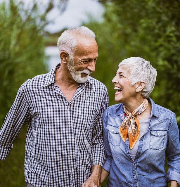 Asilomar Hotel and Conference Grounds Pacific Grove California - Elderly couple walking joyfully through lush greenery