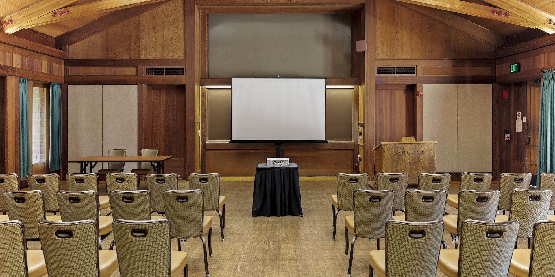 Conference room with rows of beige chairs facing Asilomar Hotel and Conference Grounds - Pacific Grove California