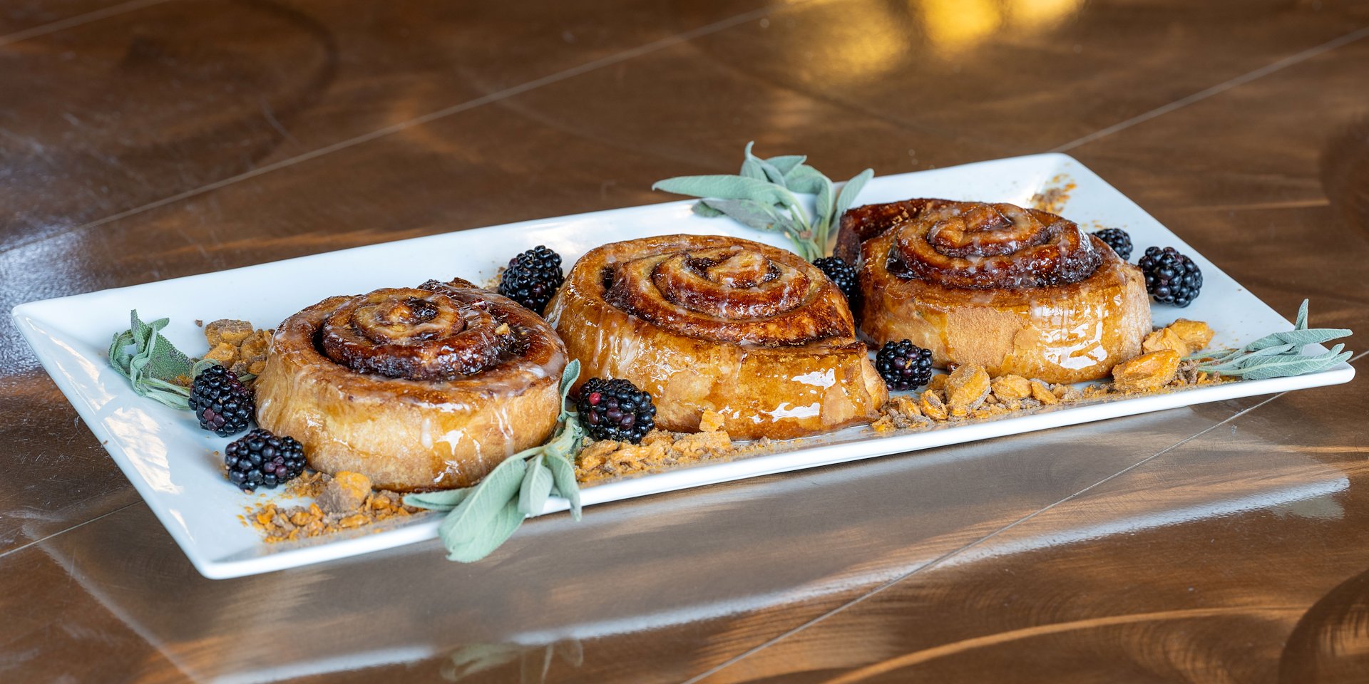 Glazed cinnamon rolls with fresh blackberries and green leaves Asilomar Hotel and Conference Grounds - Pacific Grove California