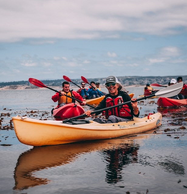 Group of people kayaking on a calm sea Asilomar Hotel and Conference Grounds - Pacific Grove California