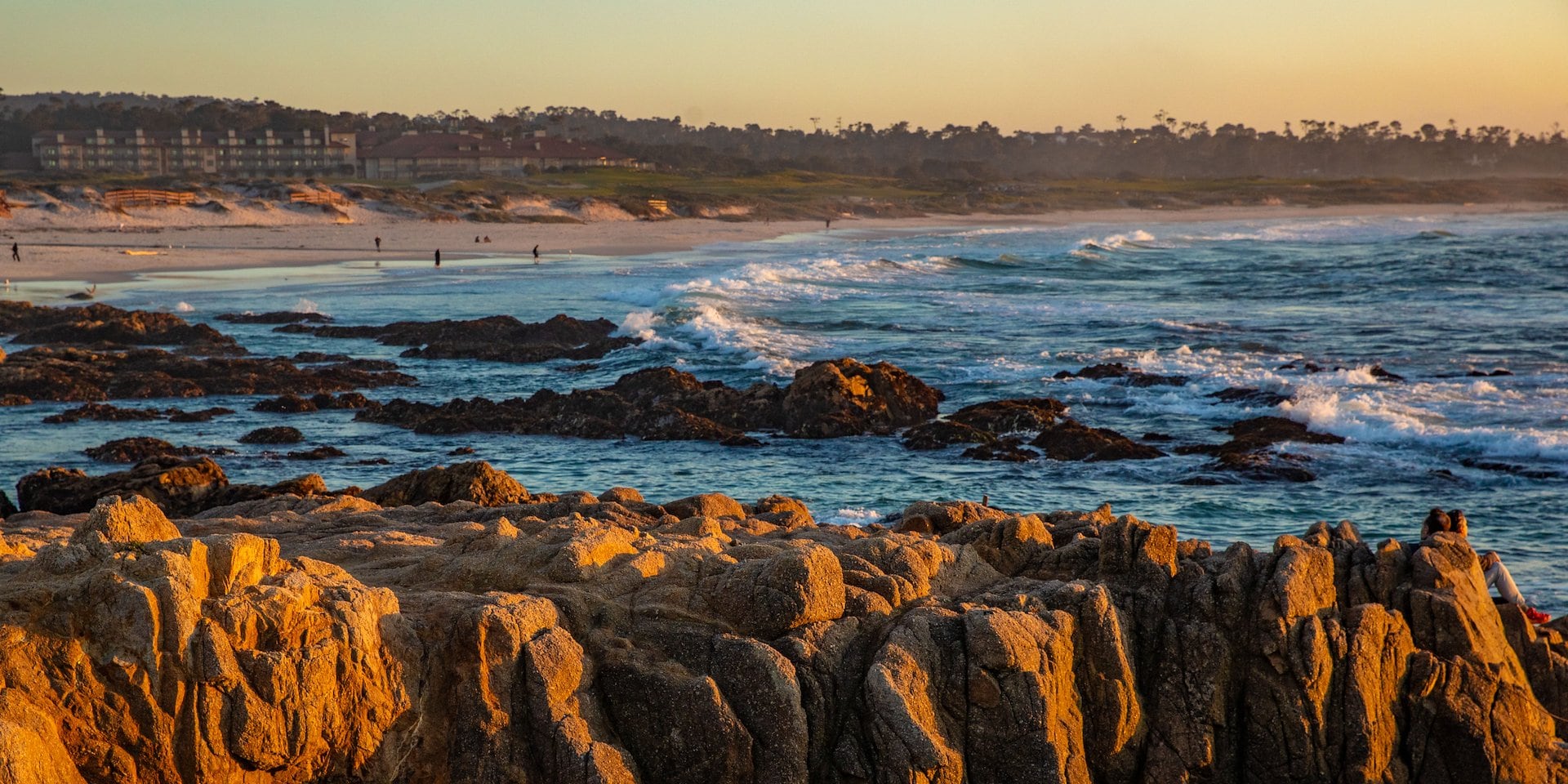 Rocky coastline at sunset with waves crashing on the shore Asilomar Hotel and Conference Grounds - Pacific Grove California
