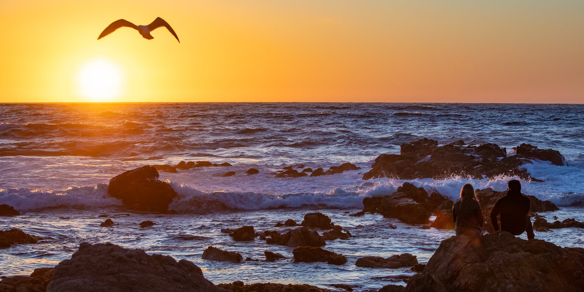 Sunset over the ocean with vibrant orange sky Asilomar Hotel and Conference Grounds - Pacific Grove California