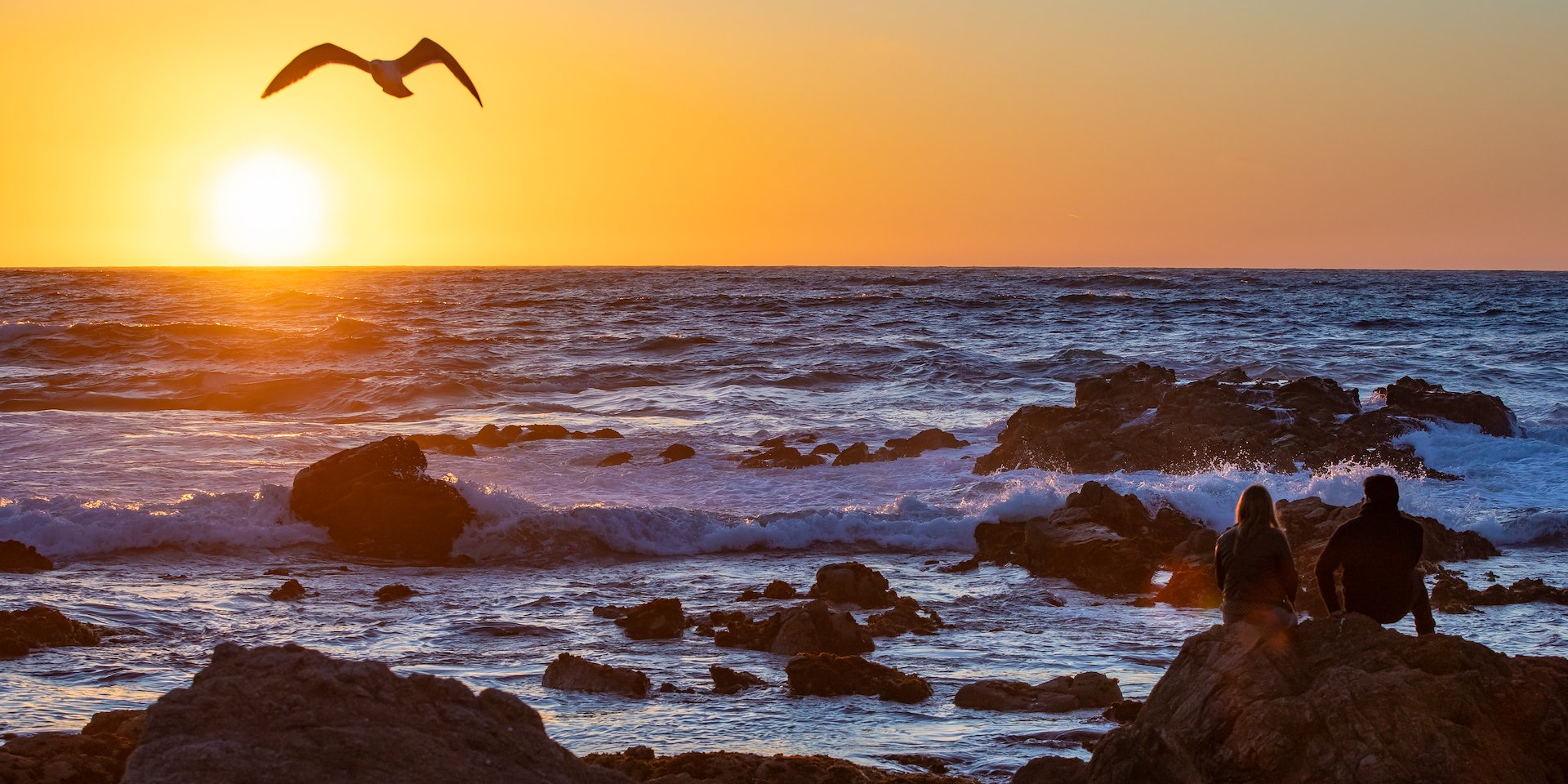 Sunset over the ocean with vibrant orange sky Asilomar Hotel and Conference Grounds - Pacific Grove California