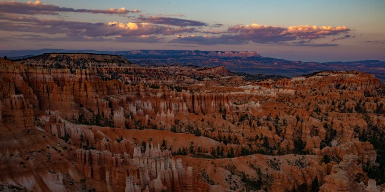 A landscape of a canyon with bryce canyon national park in the background
