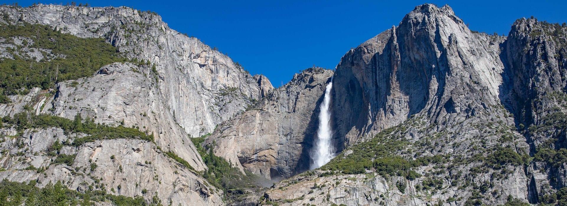 Majestic waterfall cascading down rugged cliffs Yosemite National Park Lodging and Activities - California - United States