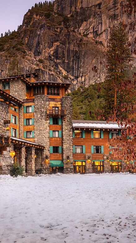 A Rustic Hotel With Stone And Wood Architecture Surrounded By Trees And Snow At Yosemite National Park Lodging And Activities - California - United States