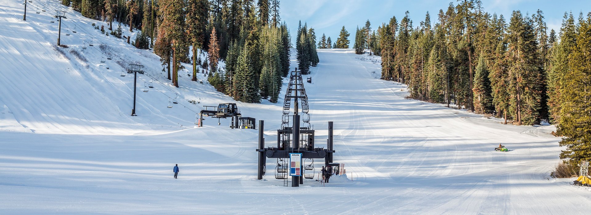 A ski lift ascends through a snowy landscape Yosemite National Park Lodging and Activities - California - United States