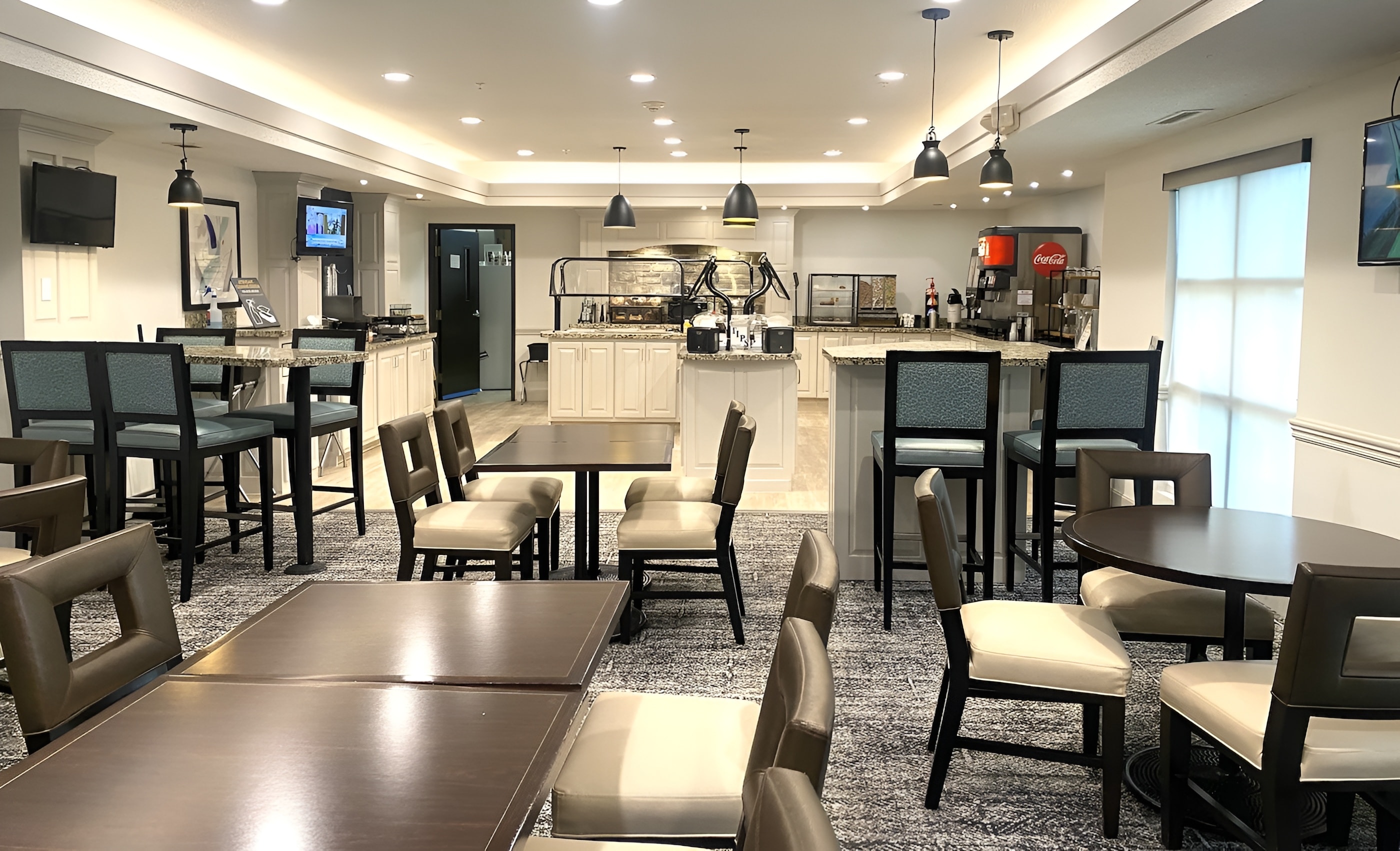 The dining area at Staybridge Suites Columbia features modern decor and seating.