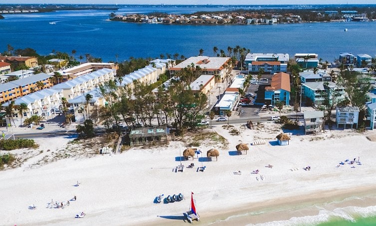 A beach with buildings and water
