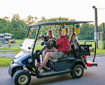 Family on golf cart