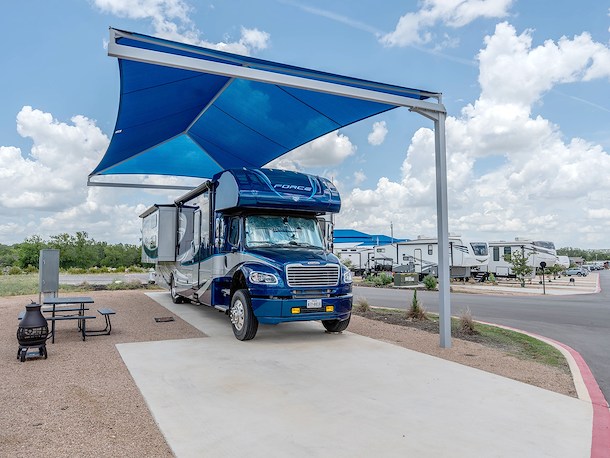Beat the heat with a covered back-In RV site at Jellystone Austin North in Georgetown, Texas - 1