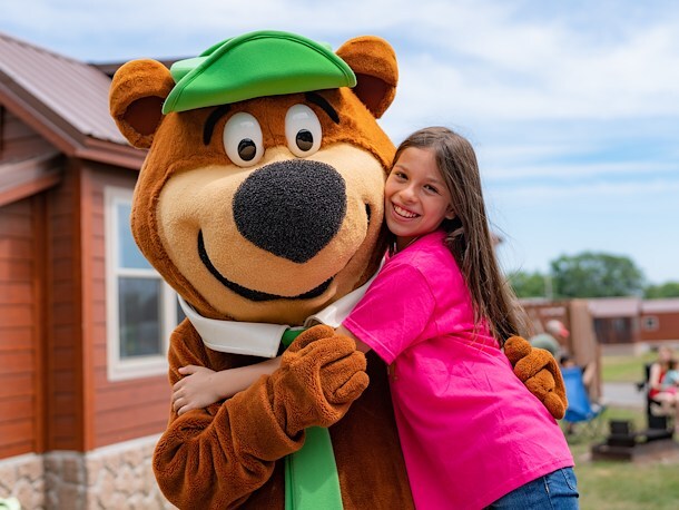girl hugging Yogi Bear