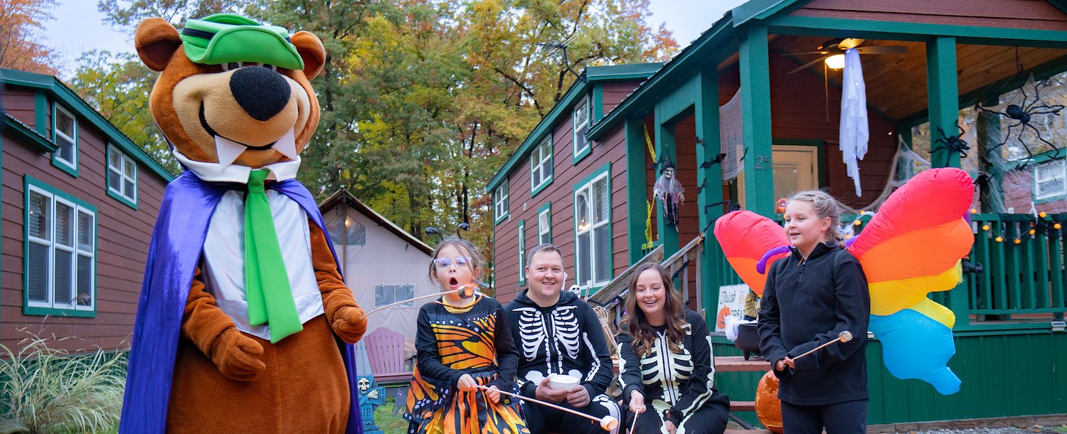 Halloween at Jellystone Park™ with Yogi Bear™ and family making S'mores